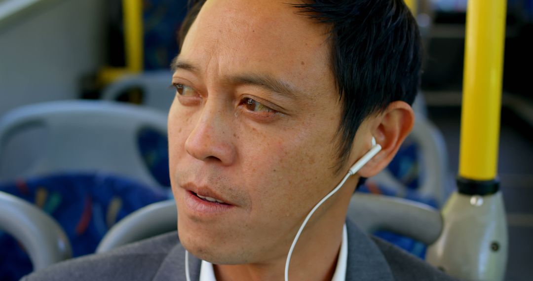 Man Commuting on Bus with Earphones, Close-Up - Free Images, Stock Photos and Pictures on Pikwizard.com