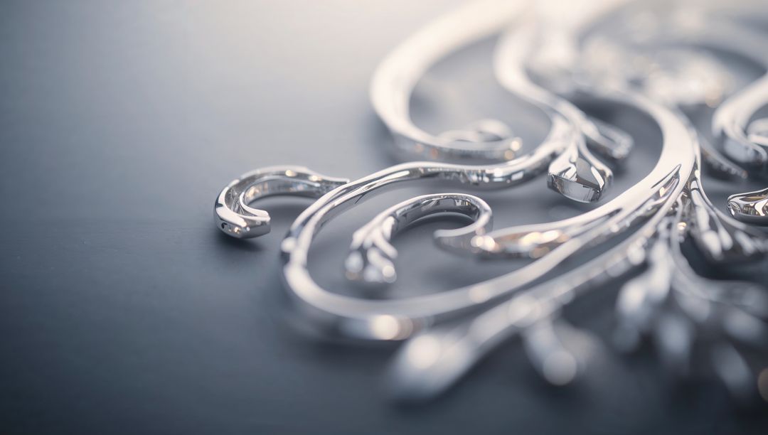 Polished Silver Filigree Close-Up Featuring Curled Scrolls and Soft Reflections
