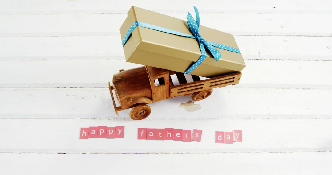 A toy truck with a gift celebrates Father's Day, symbolizing love and appreciation. - Free Images, Stock Photos and Pictures on Pikwizard.com