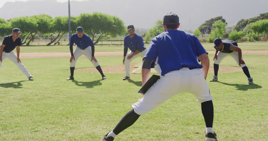 Baseball Team Warming Up During Practice in Sunny Park - Free Images, Stock Photos and Pictures on Pikwizard.com