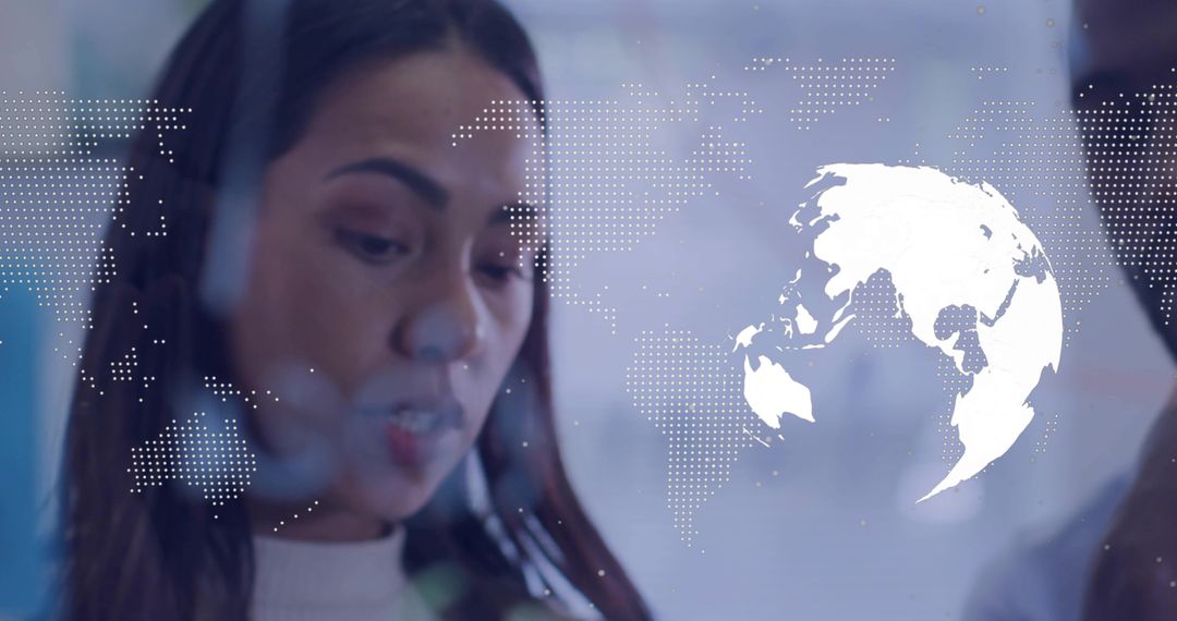 Tech Professional Examining Digital Interface with World Map Overlay