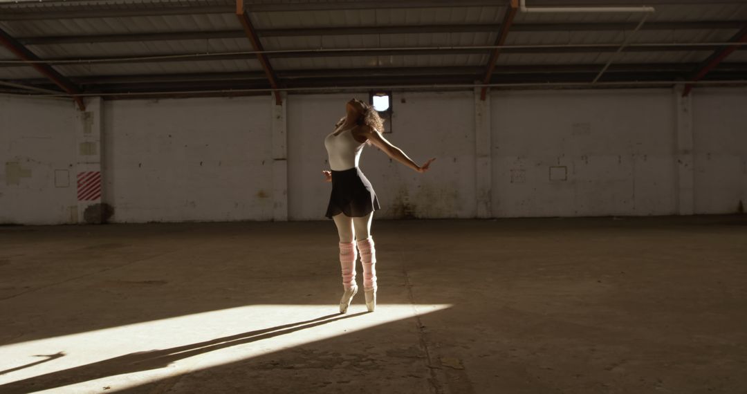 Female Dancer Performing in Abandoned Sunlit Warehouse