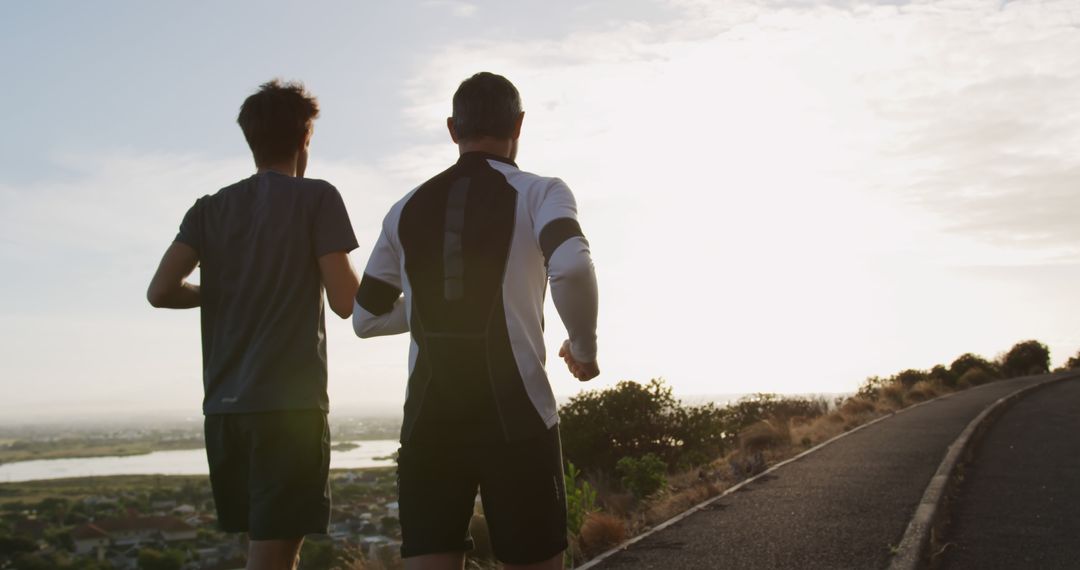 Two Men Jogging Outdoor at Sunrise on Country Road - Free Images, Stock Photos and Pictures on Pikwizard.com