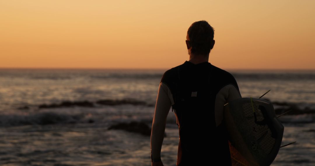 Surfer Watching Sunset at Ocean Shore - Free Images, Stock Photos and Pictures on Pikwizard.com