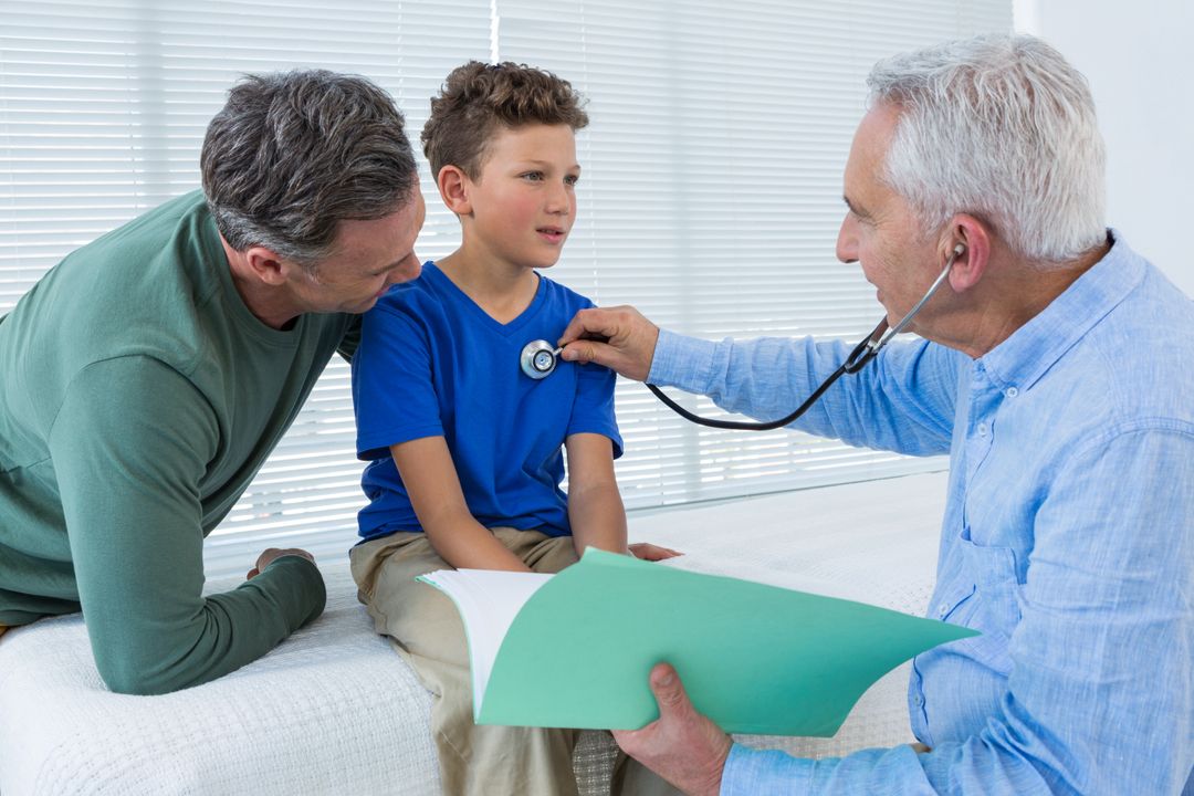 Doctor Examining Young Boy with Concerned Father - Free Images, Stock Photos and Pictures on Pikwizard.com