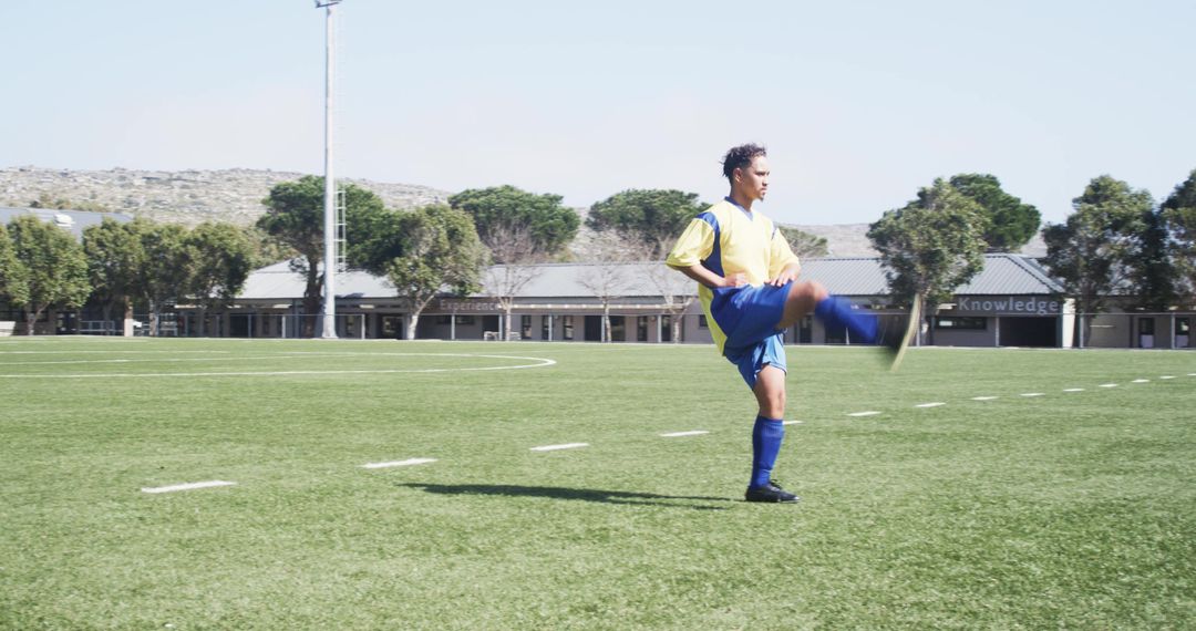 Soccer Player Practicing Kicks on Sunny Outdoor Field
