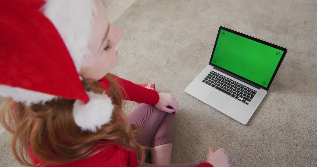 Woman with Santa Hat using Laptop with Green Screen - Free Images, Stock Photos and Pictures on Pikwizard.com