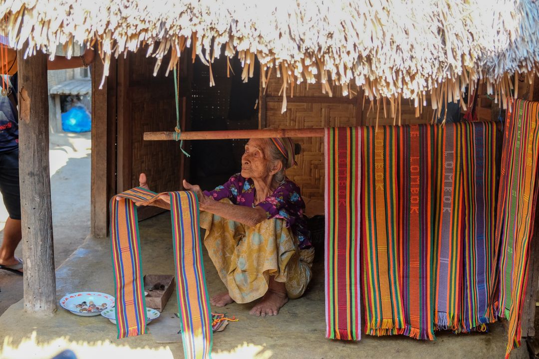 Elderly Woman Weaving Traditional Fabric in Rural Village - Free Images, Stock Photos and Pictures on Pikwizard.com