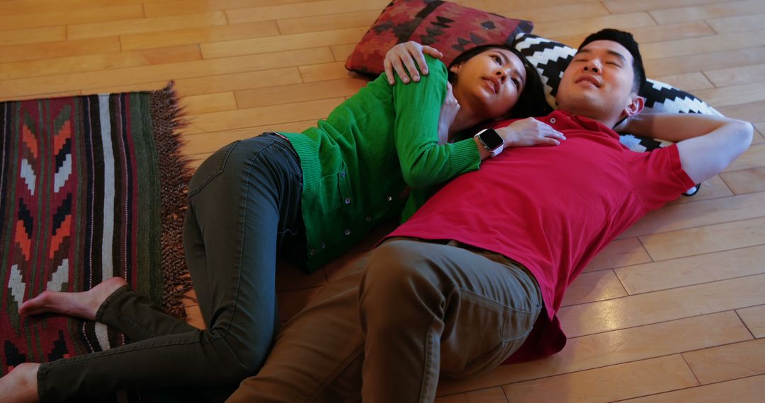 Couple Relaxing on Floor with Pillows in Cozy Home - Free Images, Stock Photos and Pictures on Pikwizard.com