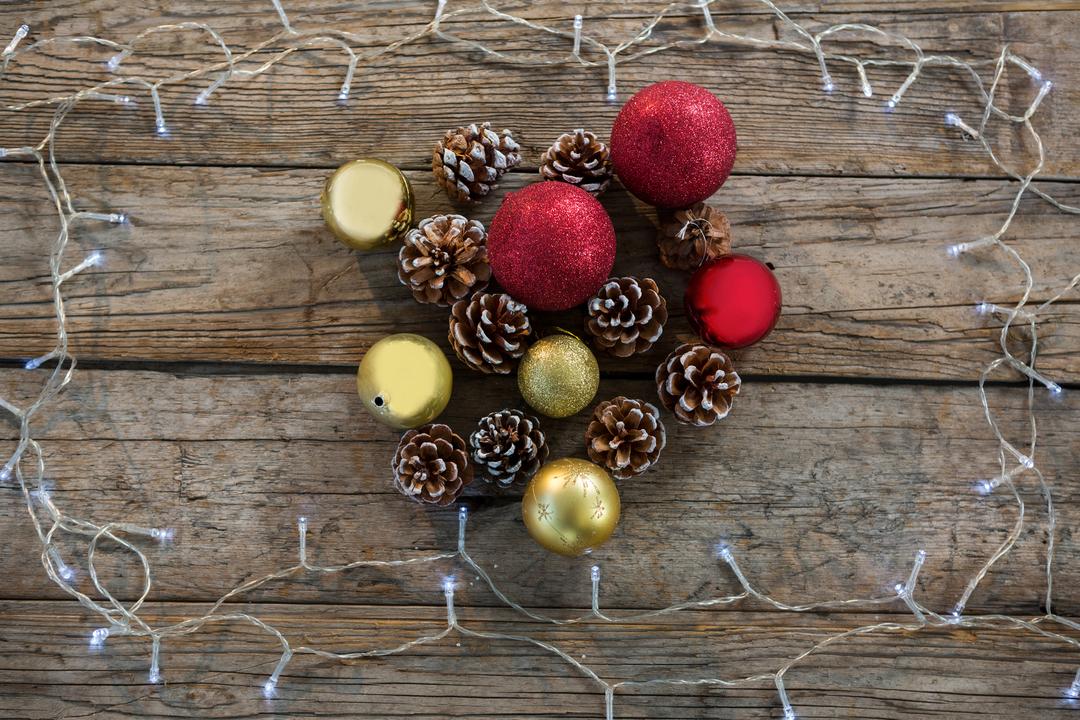 Christmas Decorations with Pine Cones and Baubles on Wooden Background - Free Images, Stock Photos and Pictures on Pikwizard.com
