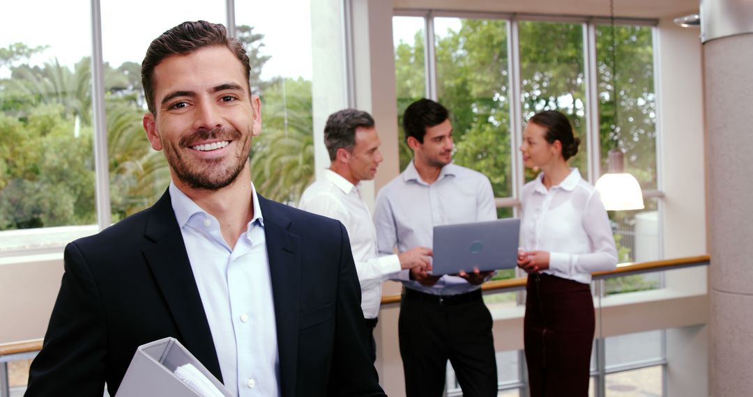 Confident Businessman Leading Team Discussion in Modern Office