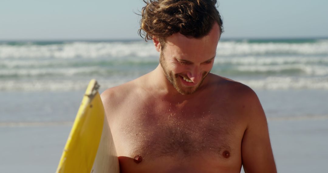 Sunlit Male Surfer Holding Yellow Surfboard at Beach - Free Images, Stock Photos and Pictures on Pikwizard.com