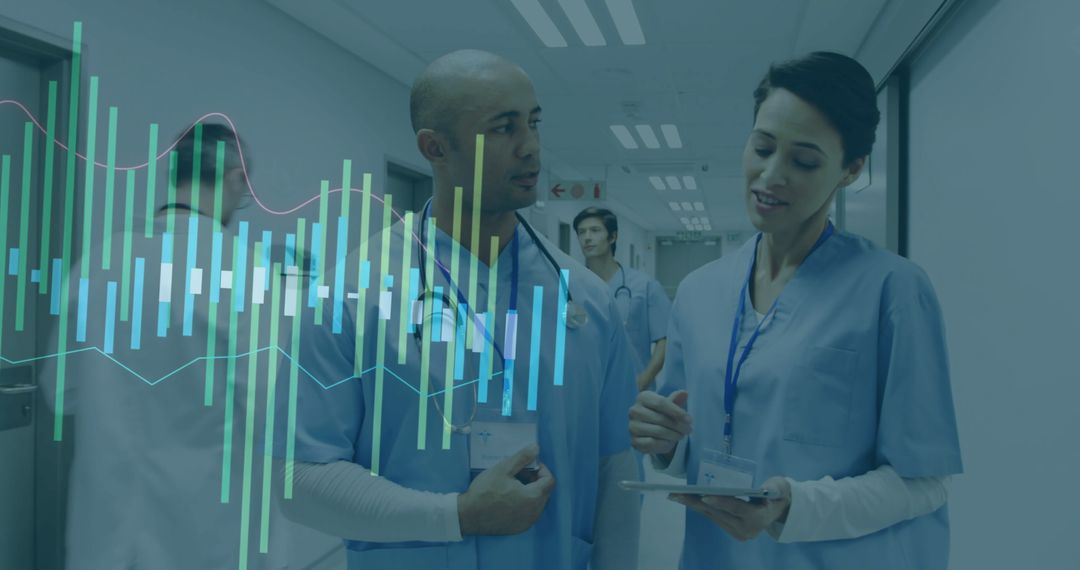 Diverse Medical Team Analyzing Digital Data in Hospital Corridor