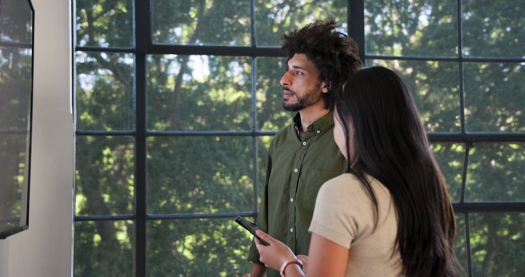 Diverse Colleagues Discussing Project in Bright Meeting Room