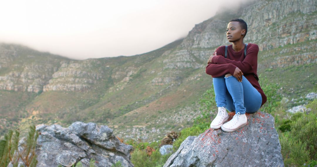 Young Woman Meditating on Rock in Mountain Landscape - Free Images, Stock Photos and Pictures on Pikwizard.com