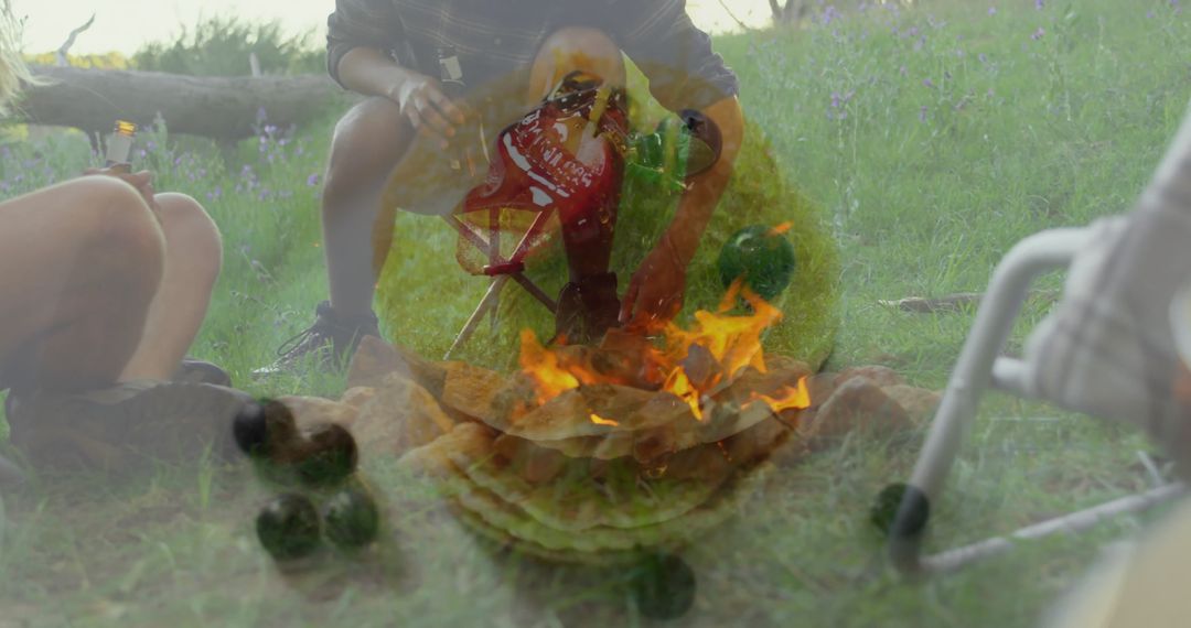 Campers Gathering Around Fire Pit in Tranquil Outdoor Setting