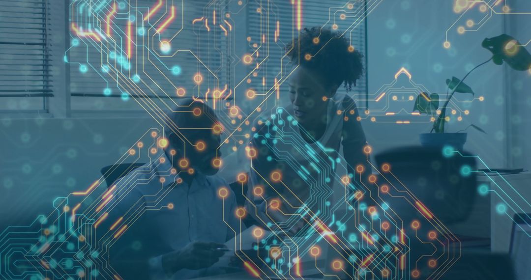 Diverse Colleagues Collaborating on Digital Project with Circuit Overlay