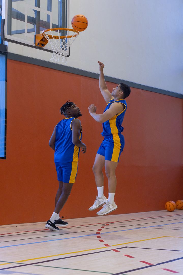 Dynamic Basketball Players in Action on Indoor Court