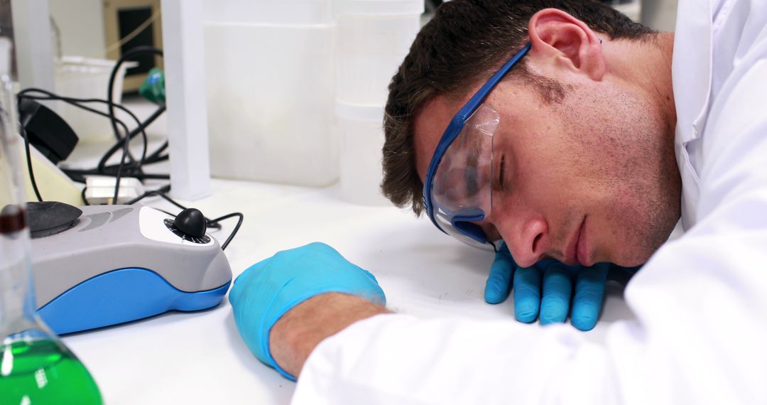 Exhausted Scientist Sleeping on Lab Desk in Laboratory - Free Images, Stock Photos and Pictures on Pikwizard.com