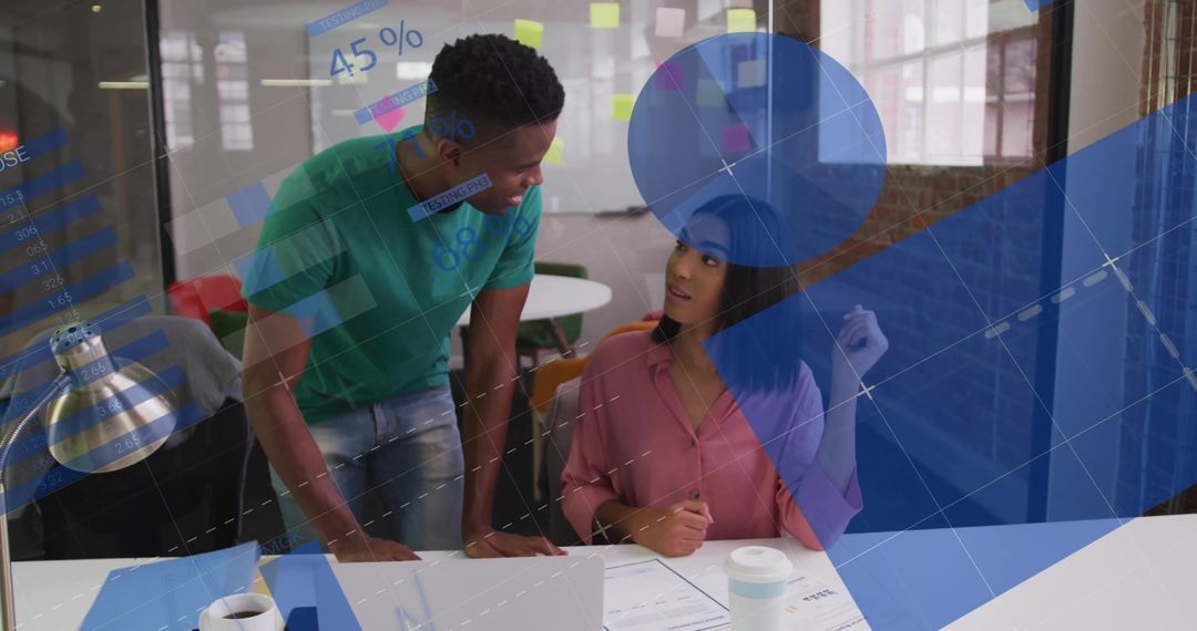 Colleagues Collaborating Over Data Visualization and Strategic Planning in Modern Office