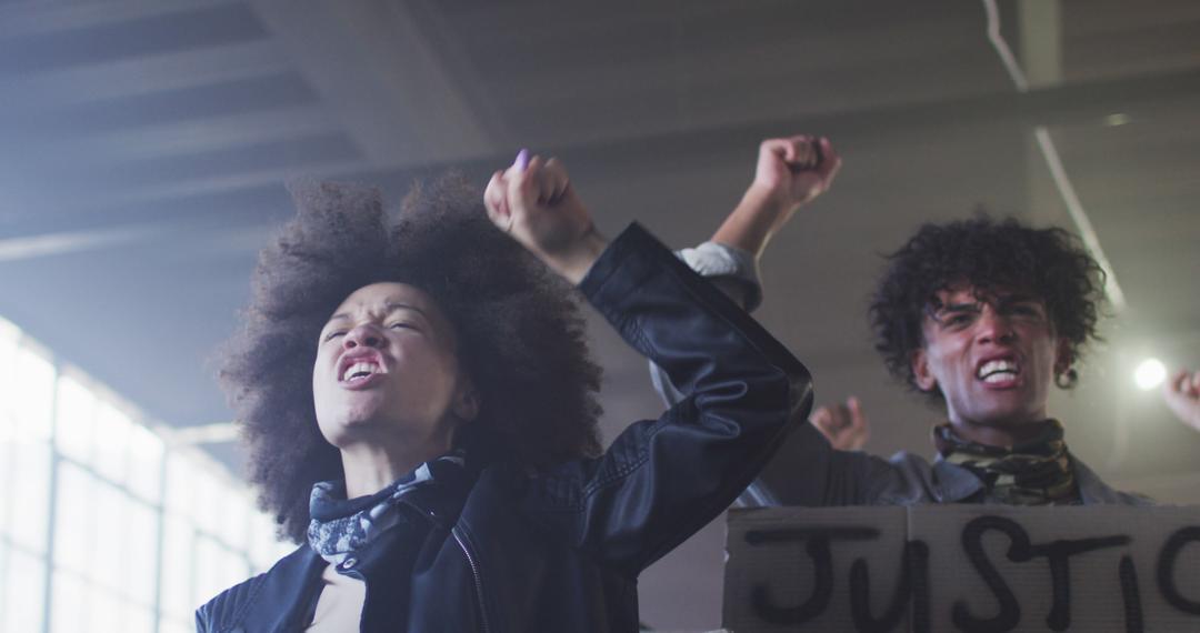 Empowered Protestors Chanting for Justice Inside Warehouse - Free Images, Stock Photos and Pictures on Pikwizard.com