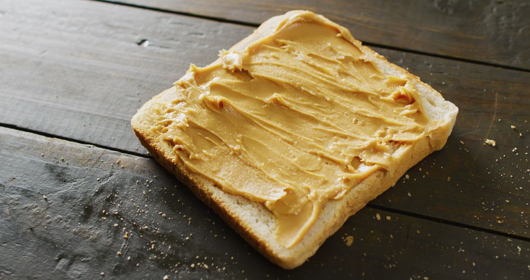 Close-Up of Peanut Butter on Toast with Rustic Wooden Background