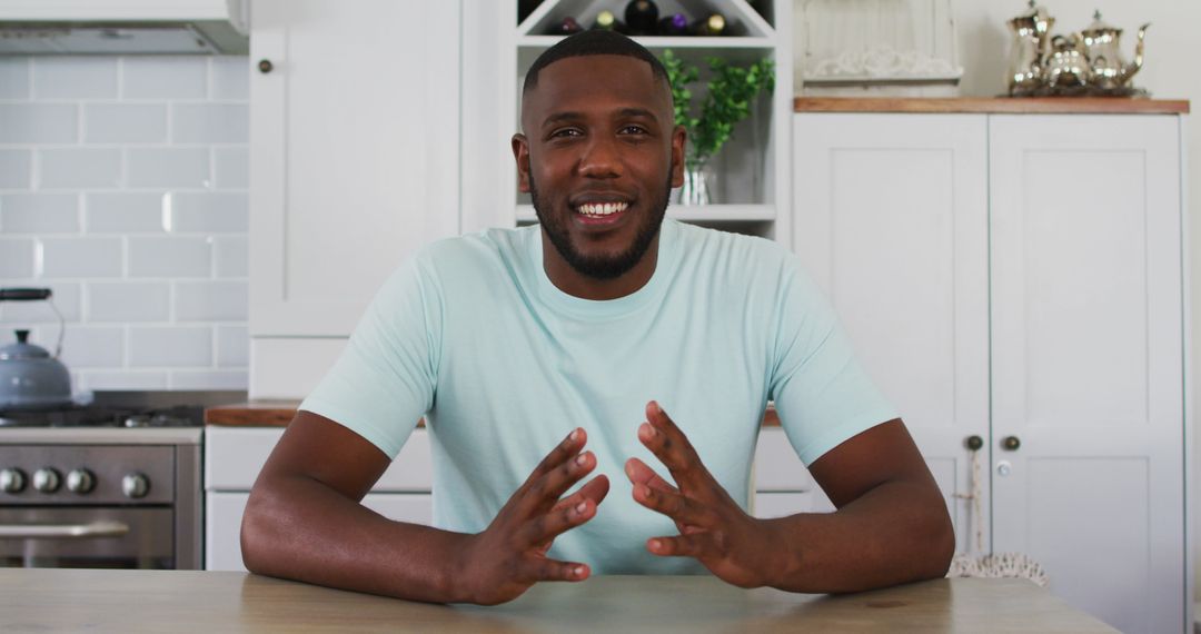 Confident Man Engaging in Video Call from Modern Kitchen