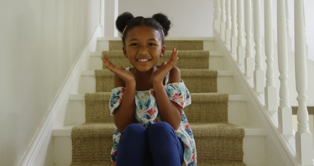 Adorable Young Girl Sitting on Staircase, Smiling Joyfully - Free Images, Stock Photos and Pictures on Pikwizard.com