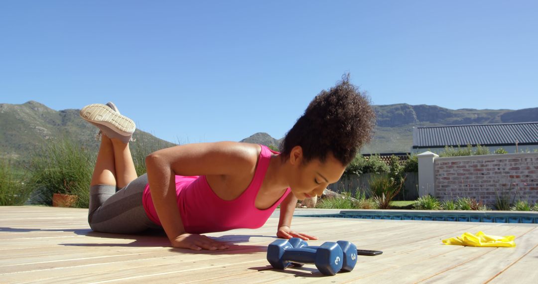 Woman Exercising Outdoors Near Pool with Dumbbells - Free Images, Stock Photos and Pictures on Pikwizard.com