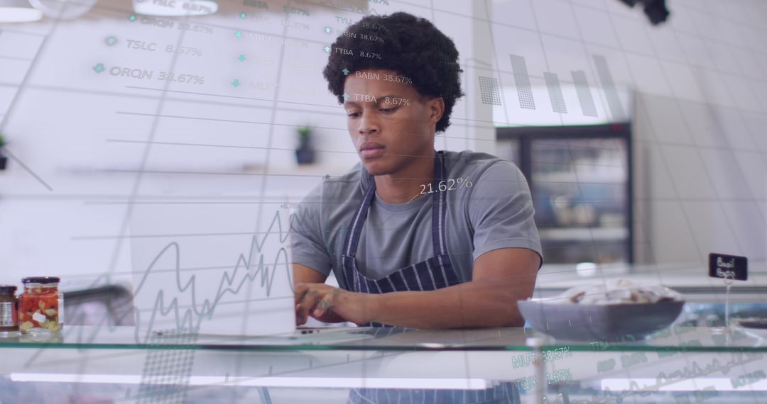 Shop Assistant Analyzing Business Data Using Laptop