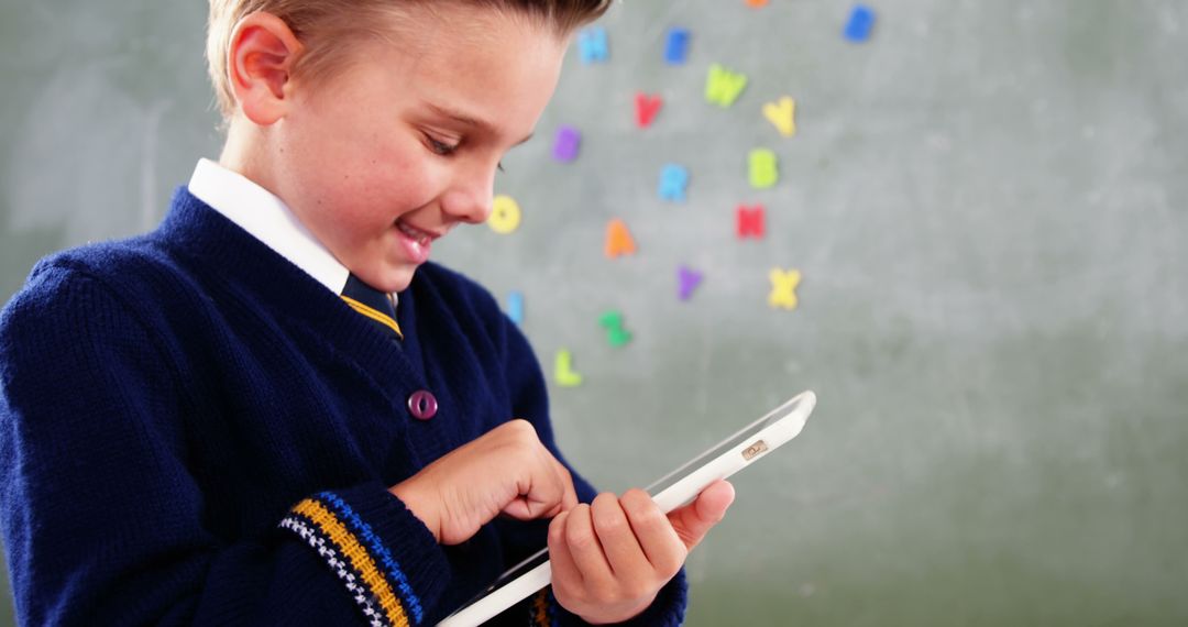Happy School Boy Using Tablet for Learning in Classroom