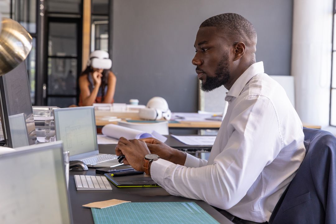 Focused Colleague Working at Modern Office Workspace with Technology