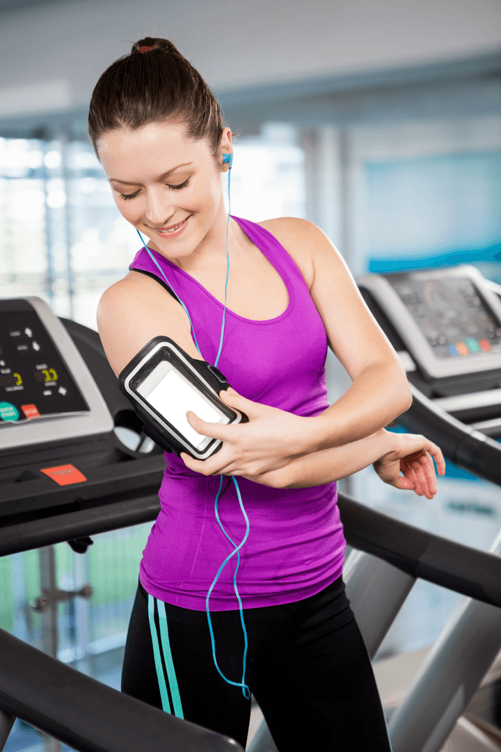 Transparent Fit Woman Using Smartphone on Treadmill in Gym