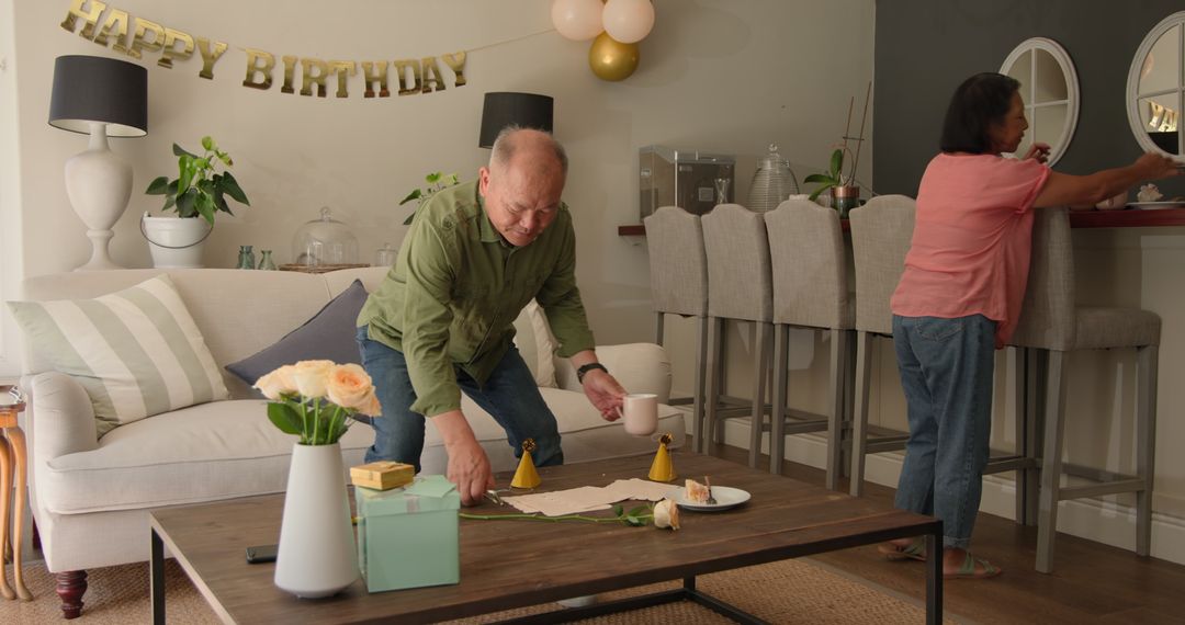Mature Couple Setting Up for Birthday Celebration at Home