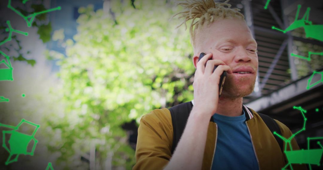 Young man with dreadlocks talking on smartphone in urban park with green graphic overlay