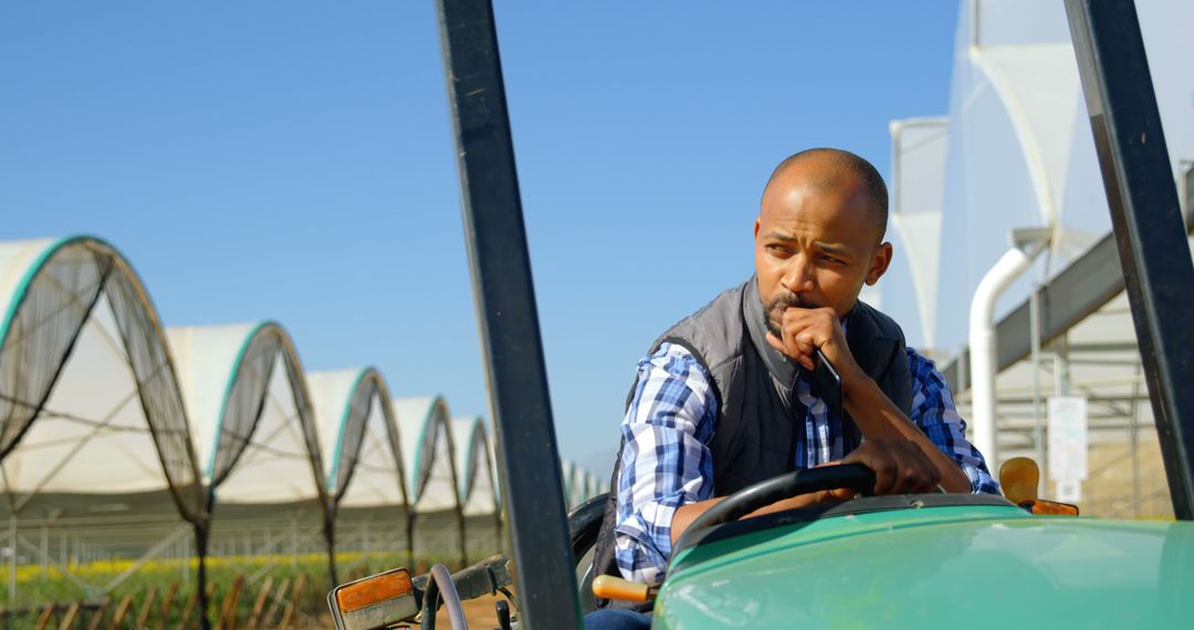 Thoughtful African American Farmer Operating Tractor on Farm - Free Images, Stock Photos and Pictures on Pikwizard.com