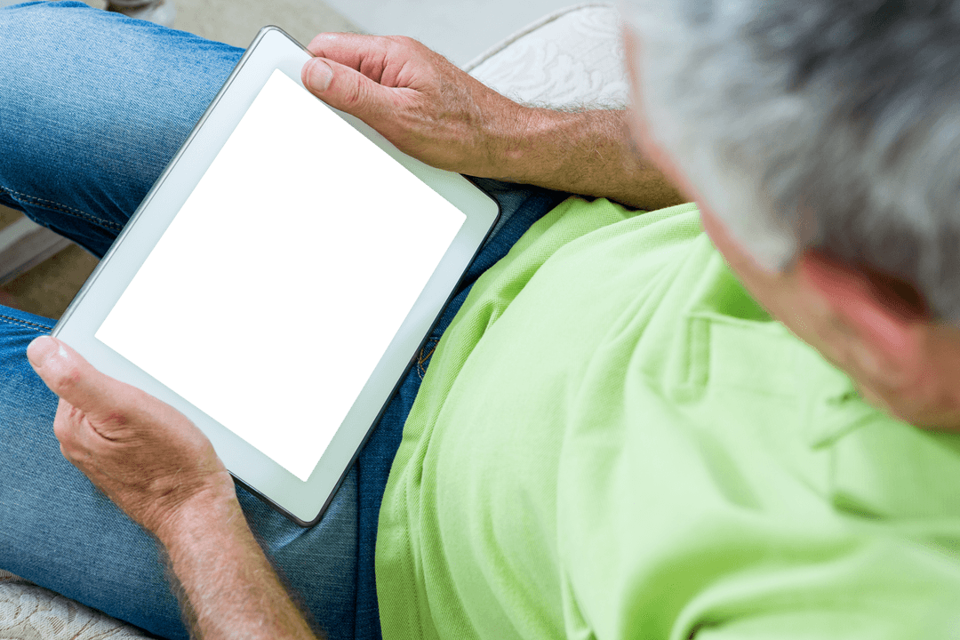 Senior Man Using Transparent Digital Tablet Device at Home