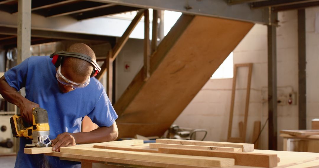 Skilled Craftsman Operating Router in Carpentry Workshop