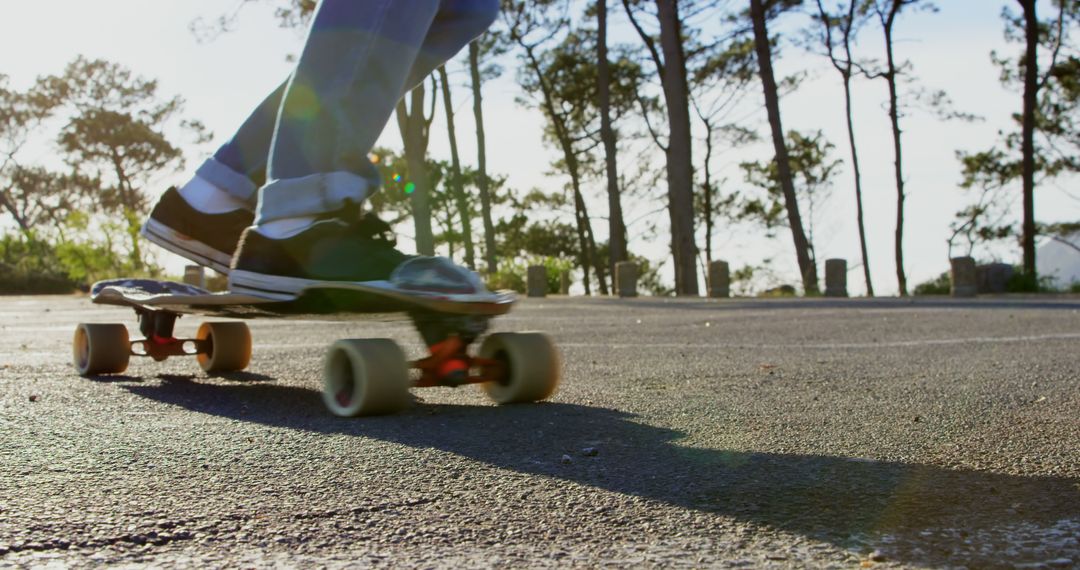 Person Riding Longboard on Asphalt Road at Park - Free Images, Stock Photos and Pictures on Pikwizard.com