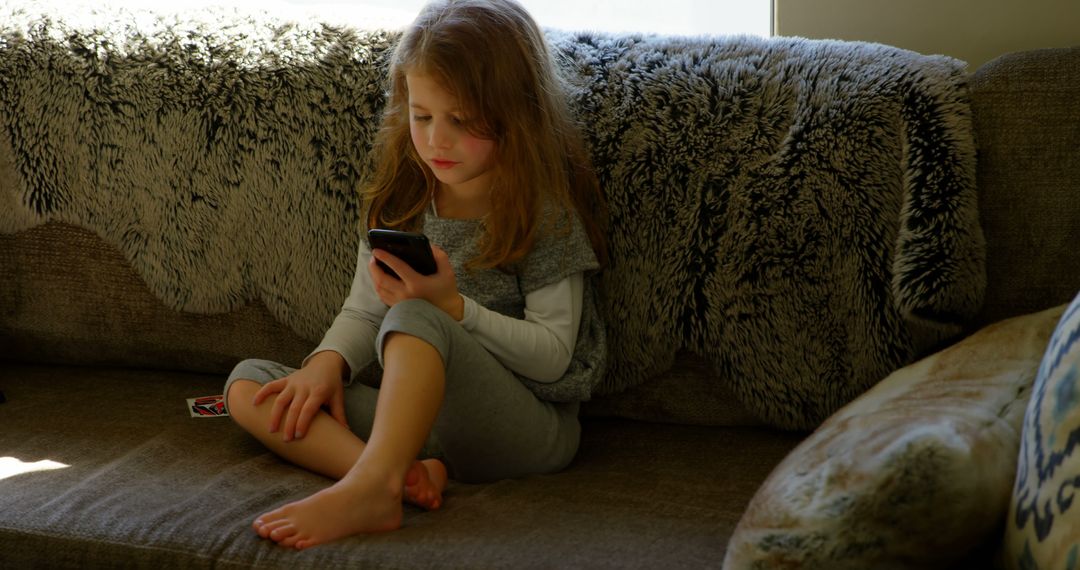 Young Girl Relaxing on Couch with Smartphone - Free Images, Stock Photos and Pictures on Pikwizard.com
