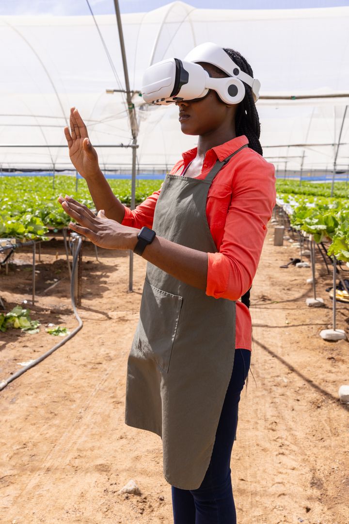 Agritech Worker Using VR Headset for Smart Farming in Greenhouse