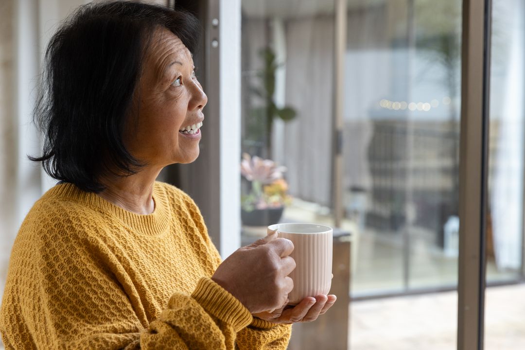 Senior Woman Embracing Serenity with Morning Coffee by Window