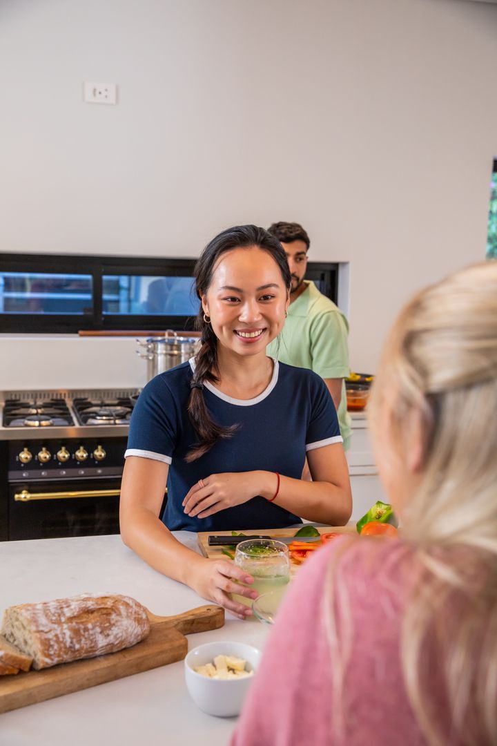Diverse Friends Enjoying Breakfast Preparation in Modern Kitchen