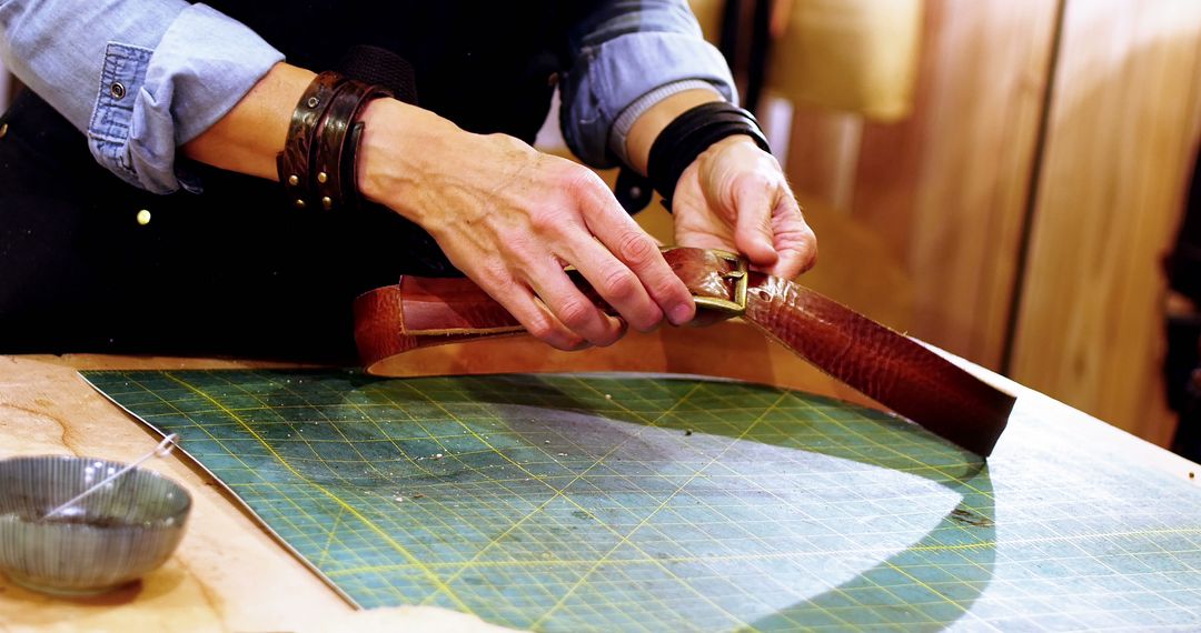 Hands Crafting Leather Belts with Tools - Free Images, Stock Photos and Pictures on Pikwizard.com