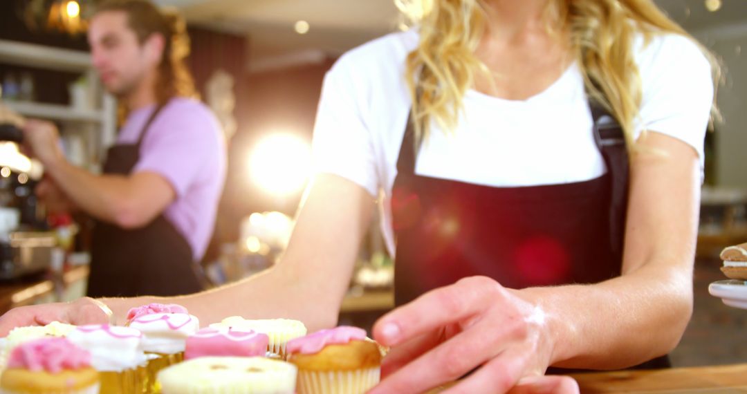 Female Baker Preparing Decorative Cupcakes in Bright Bakery - Free Images, Stock Photos and Pictures on Pikwizard.com