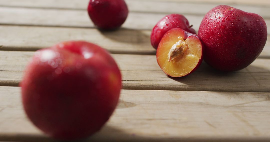 Fresh Red Plums on Wooden Table with Water Droplets - Free Images, Stock Photos and Pictures on Pikwizard.com