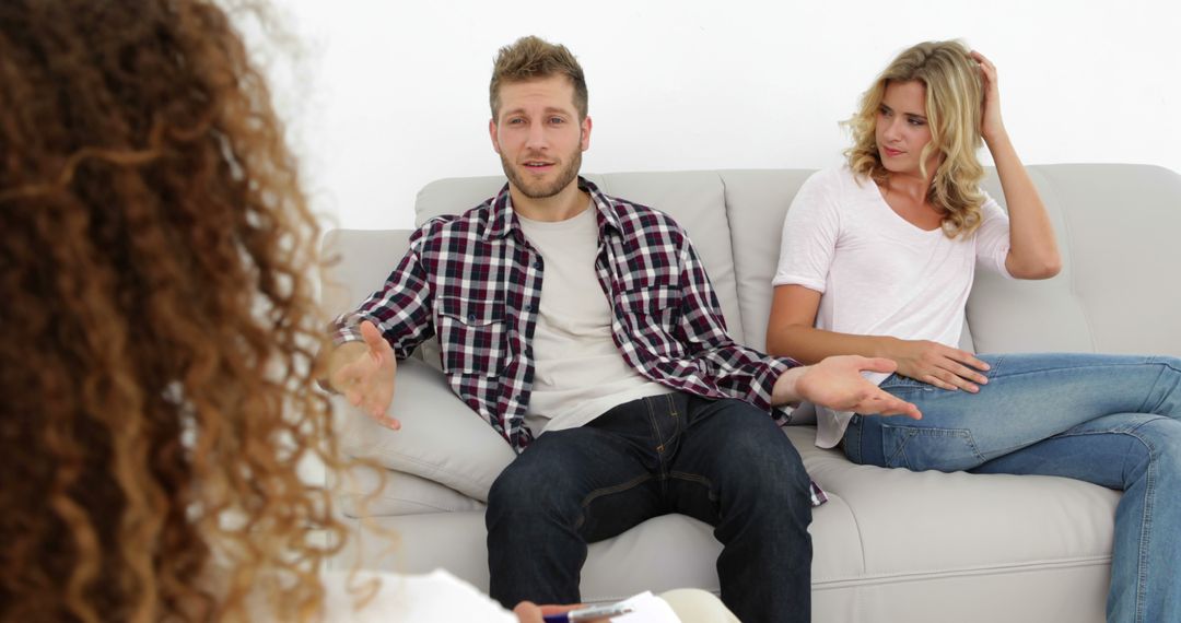 Young couple in intense discussion during therapy session