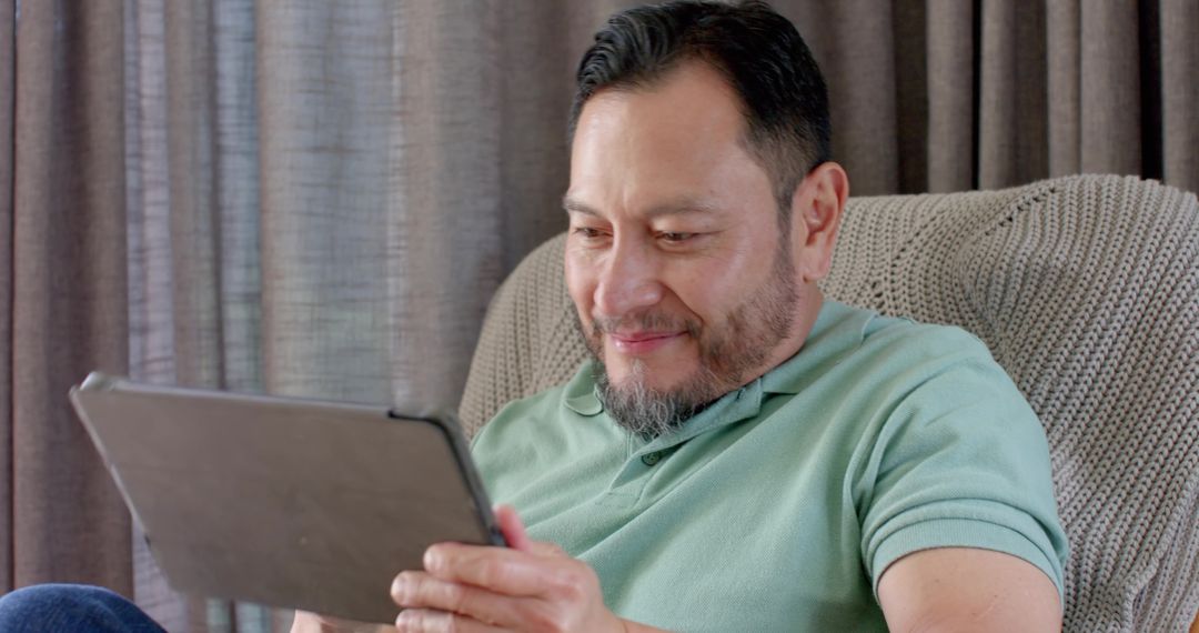 Asian Man Using Tablet at Home Embracing Modern Lifestyle
