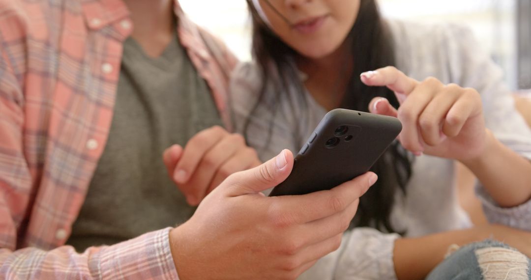 Couple Using Smartphone on Couch in Relaxed Home Environment