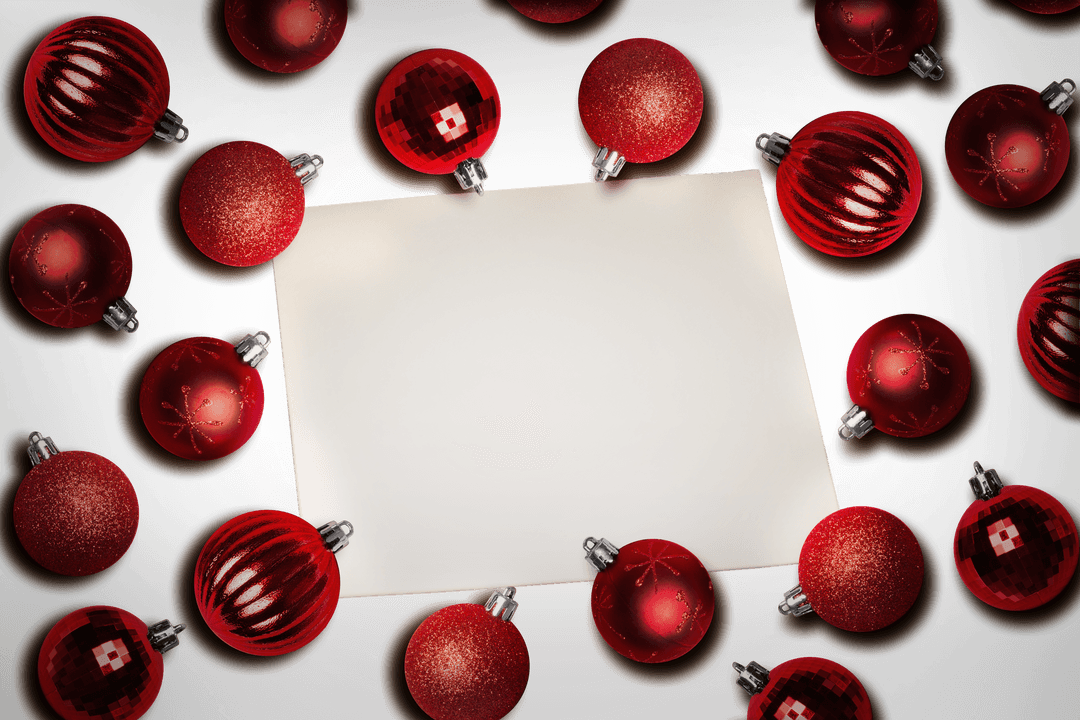 Red Ornaments Arranged Around White Paper on Transparent Background